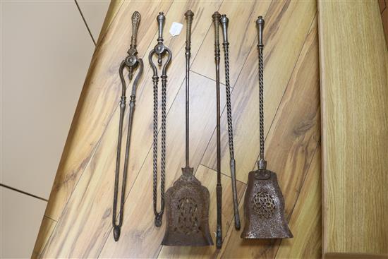 A set of three George III steel and brass fire irons and a set of three steel fire irons